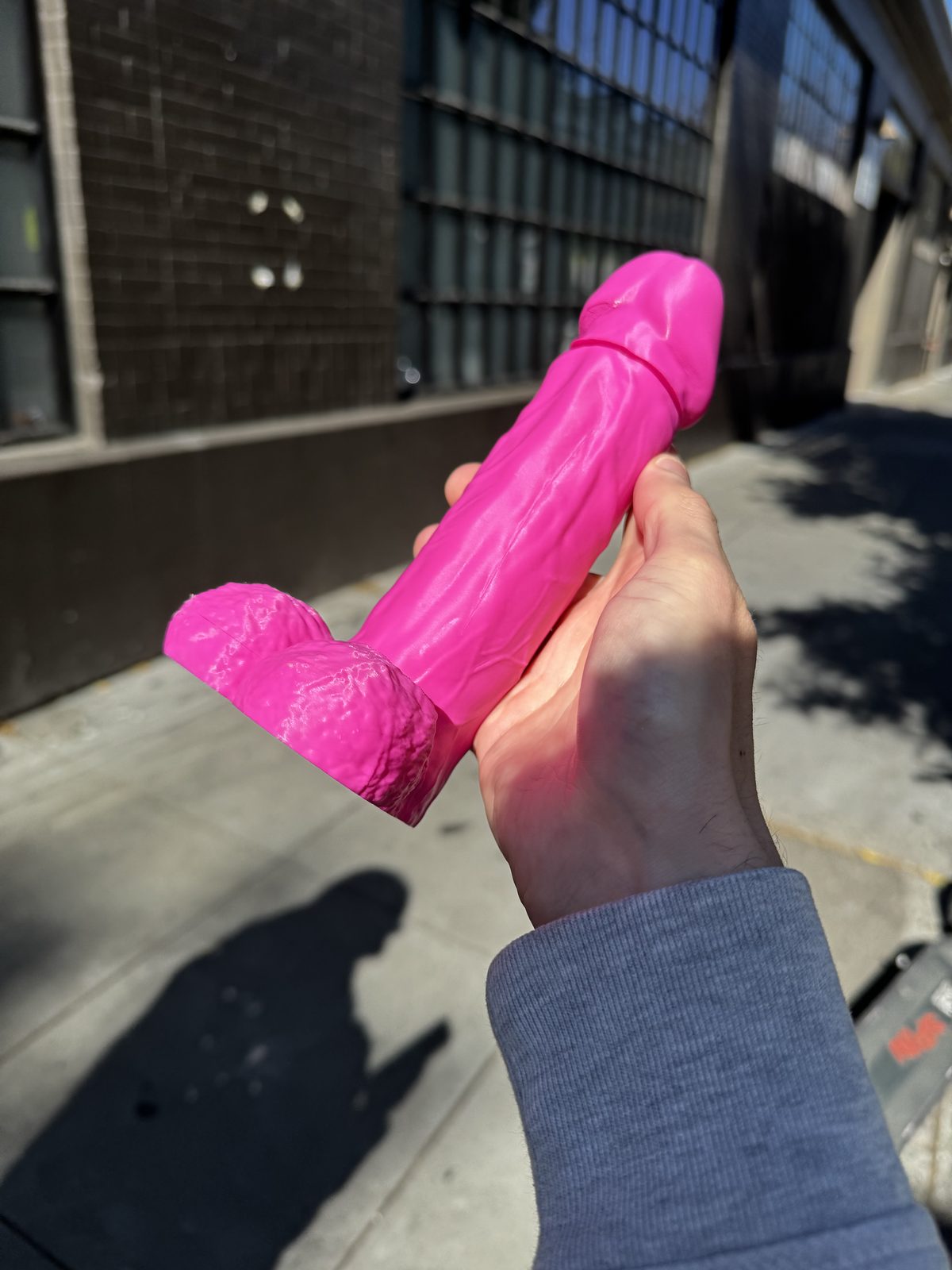 Pink Dickstendo held outdoors