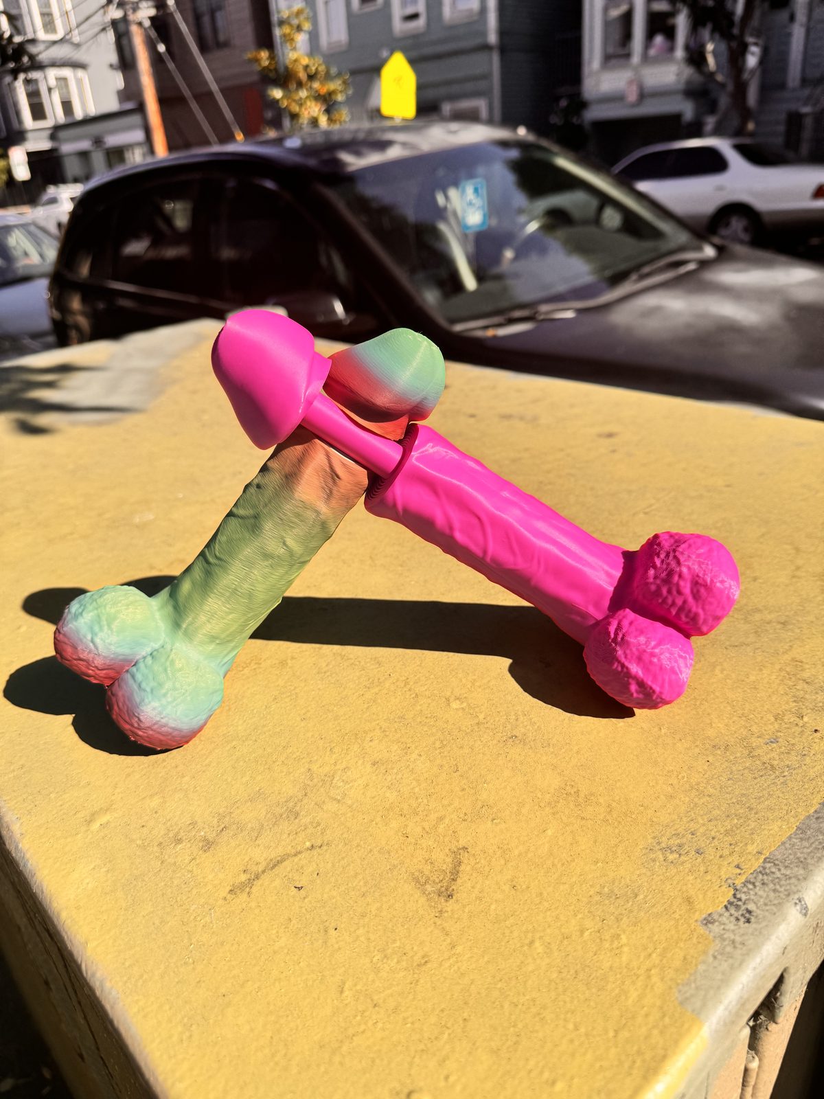Pink and green Dickstendo objects on a box