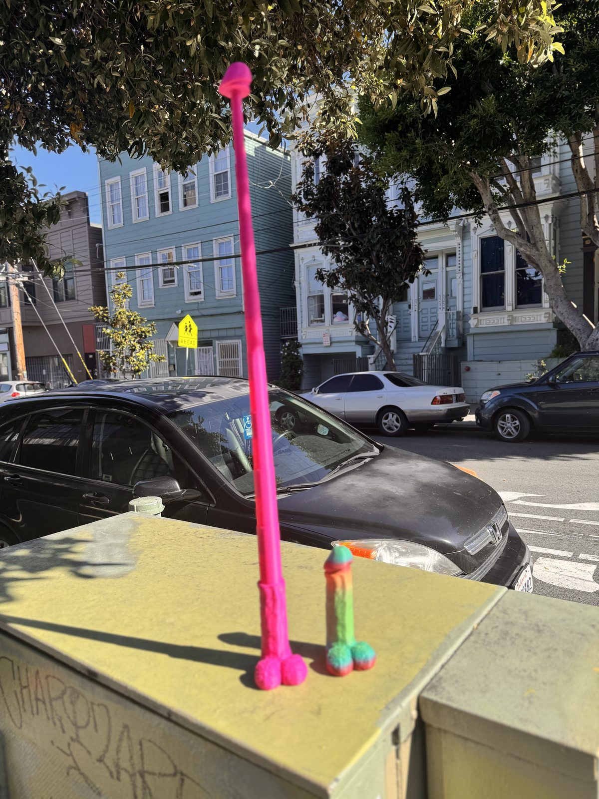 Tall pink Dickstendo object in street setting