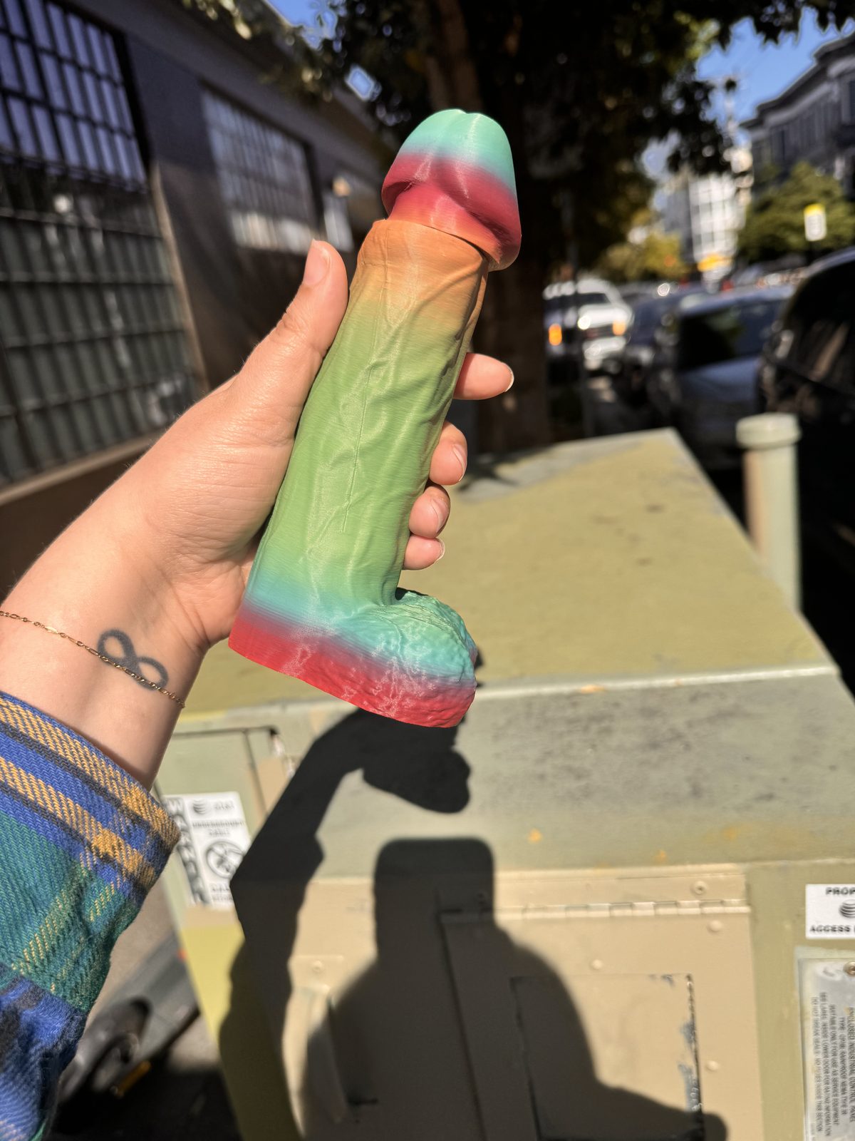 Green Dickstendo held in hand